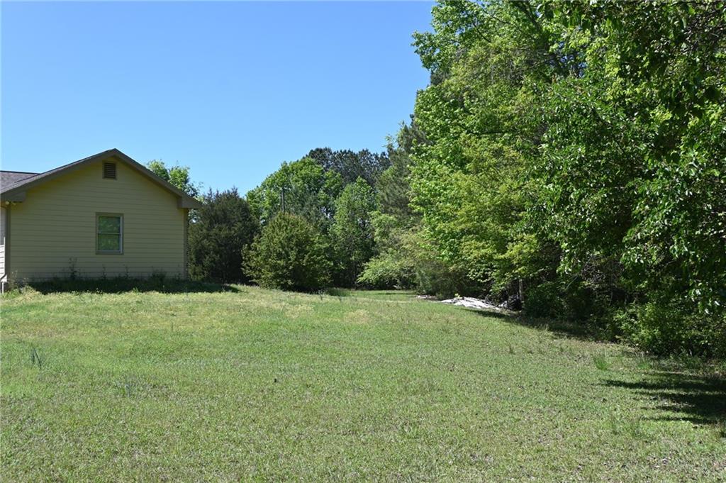 2755 Langley Road Southwest Loganville, GA 30052 - Photo 12 of 49 a backyard of a house with lots of green space