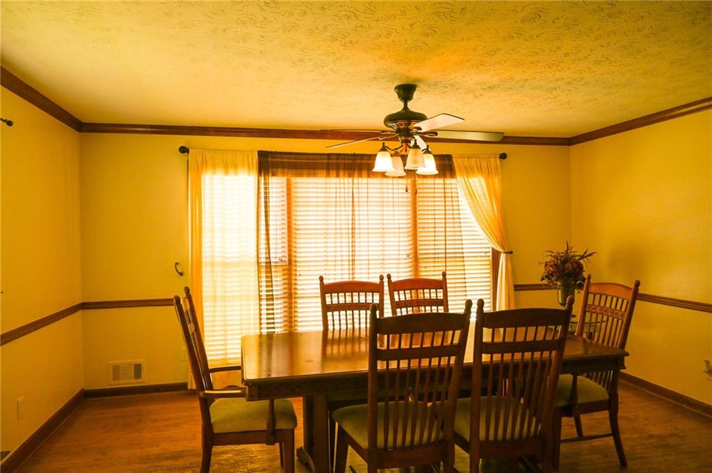 2755 Langley Road Southwest Loganville, GA 30052 - Photo 18 of 49 a view of a dining room with furniture and a window