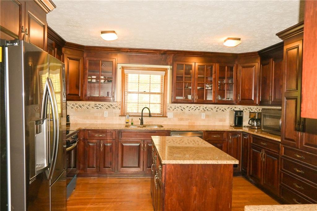 2755 Langley Road Southwest Loganville, GA 30052 - Photo 19 of 49 a kitchen with a sink a stove and cabinets