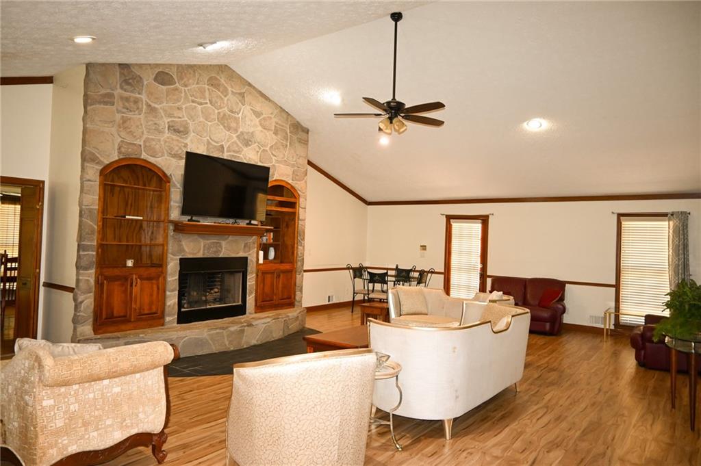 2755 Langley Road Southwest Loganville, GA 30052 - Photo 27 of 49 a living room with furniture a fireplace and a flat screen tv