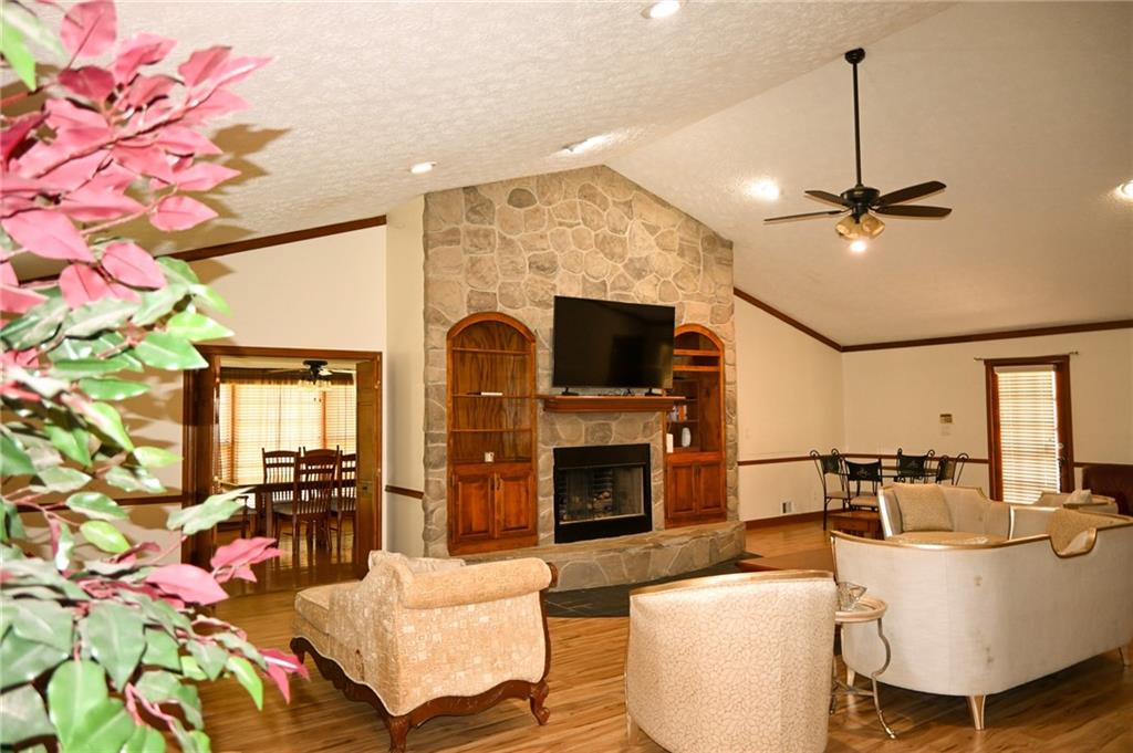 2755 Langley Road Southwest Loganville, GA 30052 - Photo 28 of 49 a living room with fireplace furniture and a chandelier