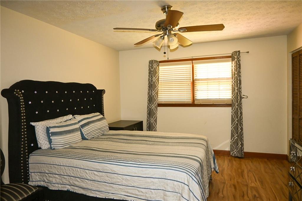 2755 Langley Road Southwest Loganville, GA 30052 - Photo 31 of 49 a bedroom with a bed and wooden floor