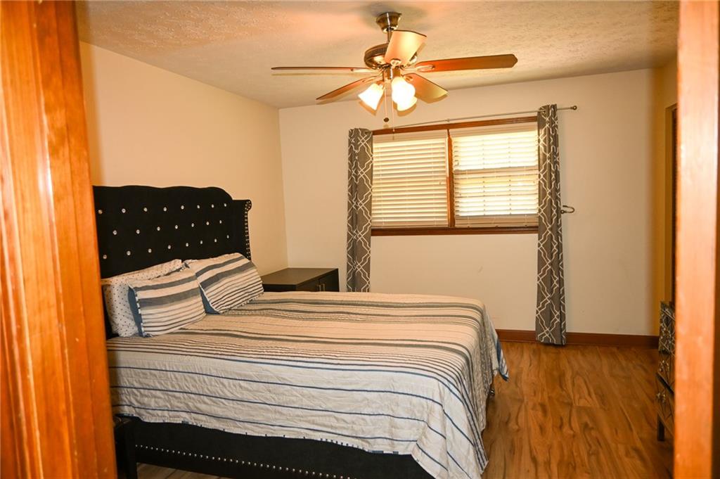 2755 Langley Road Southwest Loganville, GA 30052 - Photo 32 of 49 a bedroom with a bed and wooden floor