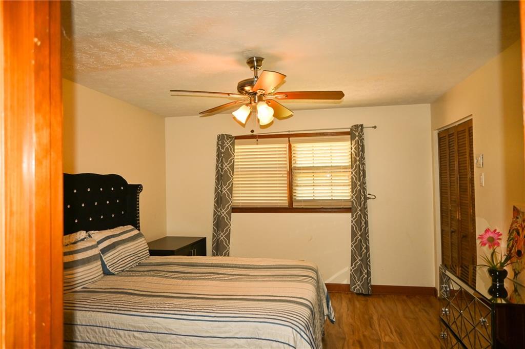 2755 Langley Road Southwest Loganville, GA 30052 - Photo 33 of 49 a bedroom with a bed and a chandelier