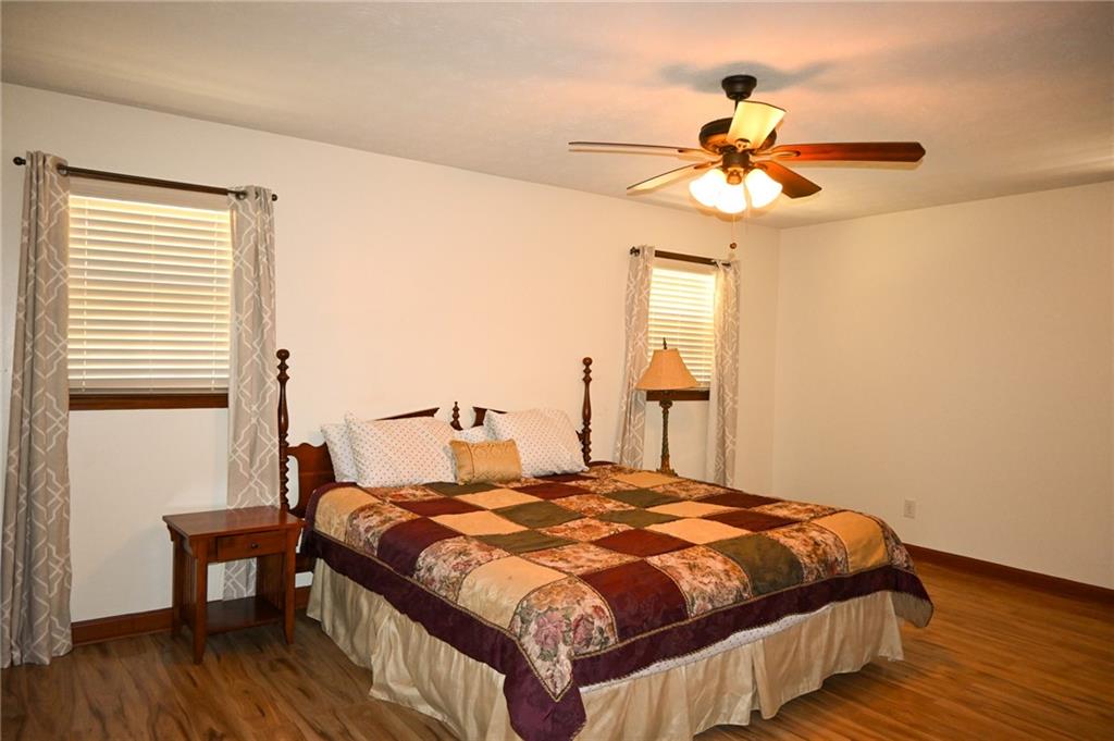 2755 Langley Road Southwest Loganville, GA 30052 - Photo 35 of 49 a bedroom with a bed and a chandelier