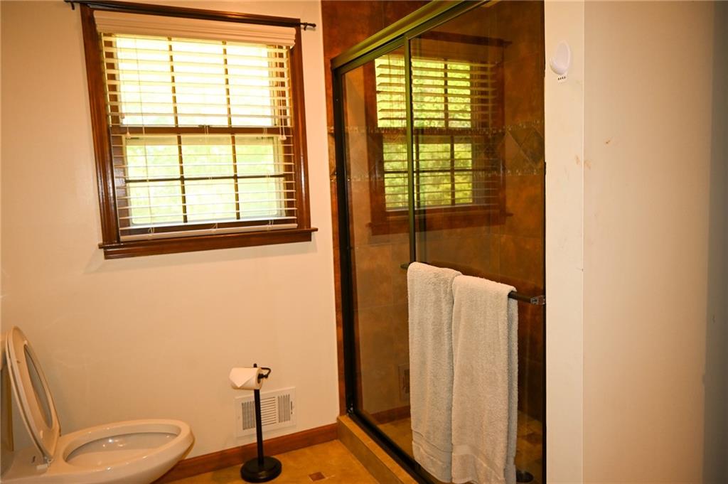 2755 Langley Road Southwest Loganville, GA 30052 - Photo 36 of 49 a bathroom with a toilet a sink and a window