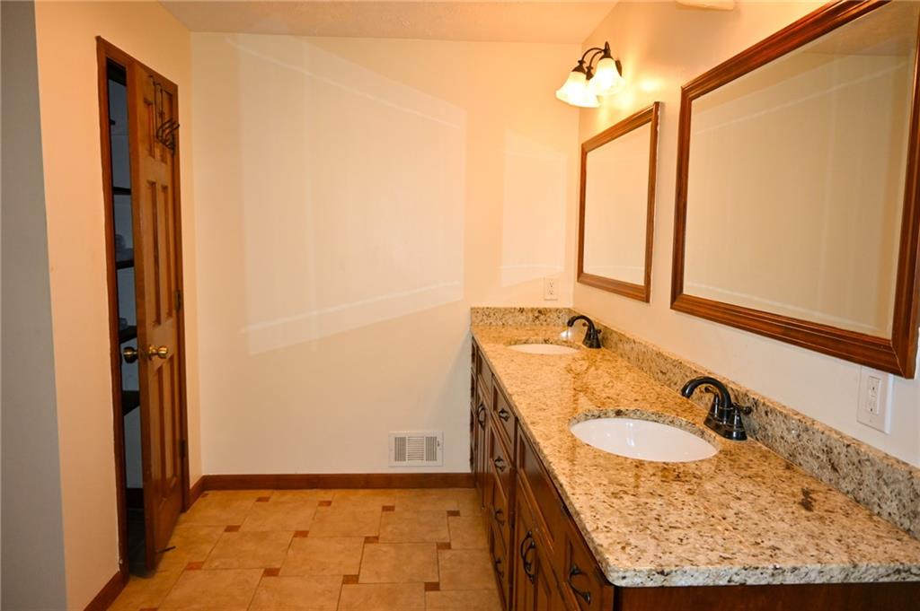 2755 Langley Road Southwest Loganville, GA 30052 - Photo 37 of 49 a bathroom with a granite countertop sink and a mirror
