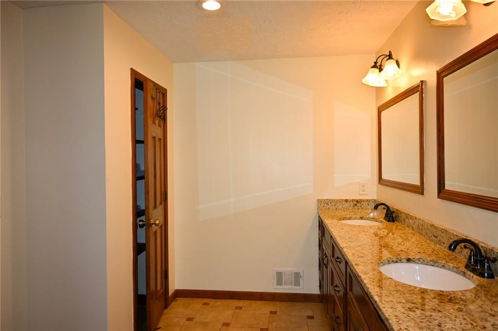 2755 Langley Road Southwest Loganville, GA 30052 - Photo 38 of 49 a bathroom with a granite countertop sink and a mirror