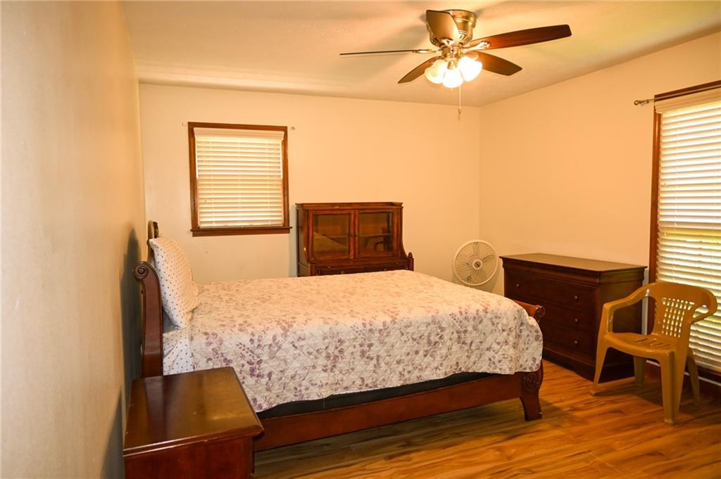 2755 Langley Road Southwest Loganville, GA 30052 - Photo 40 of 49 a bedroom with a bed and a chandelier