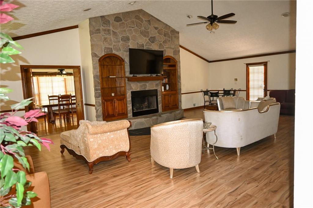 2755 Langley Road Southwest Loganville, GA 30052 - Photo 43 of 49 a living room with furniture a fireplace and a wooden floor
