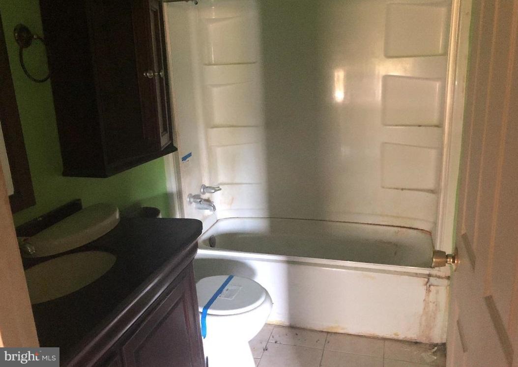 12484 Rousby Hall Road Lusby, MD 20657 - Photo 3 of 11 a bathroom with a bathtub and a sink