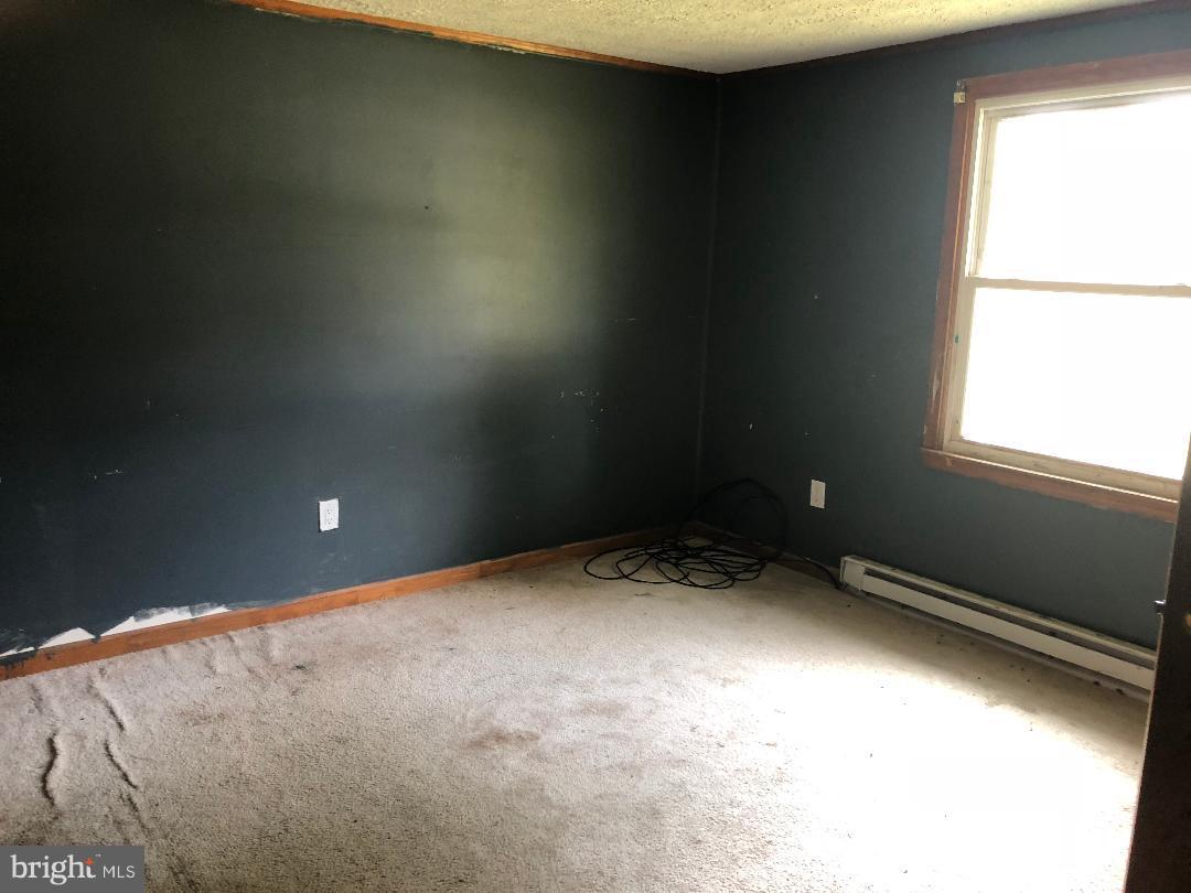 12484 Rousby Hall Road Lusby, MD 20657 - Photo 6 of 11 a view of an empty room and a window