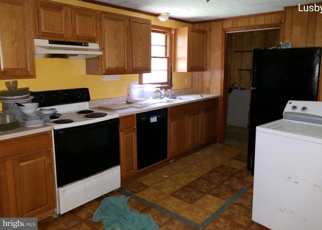 12484 Rousby Hall Road Lusby, MD 20657 - Photo 8 of 11 a kitchen with a sink appliances and cabinets