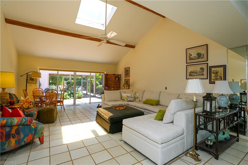 550 3rd Avenue North Naples, FL 34102 - Photo 19 of 48 a living room with furniture and a floor to ceiling window