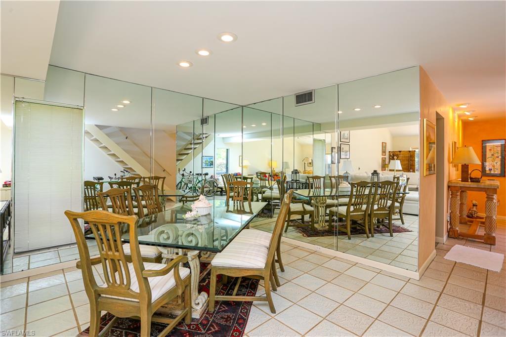 550 3rd Avenue North Naples, FL 34102 - Photo 21 of 48 a dining room with furniture and a floor to ceiling window