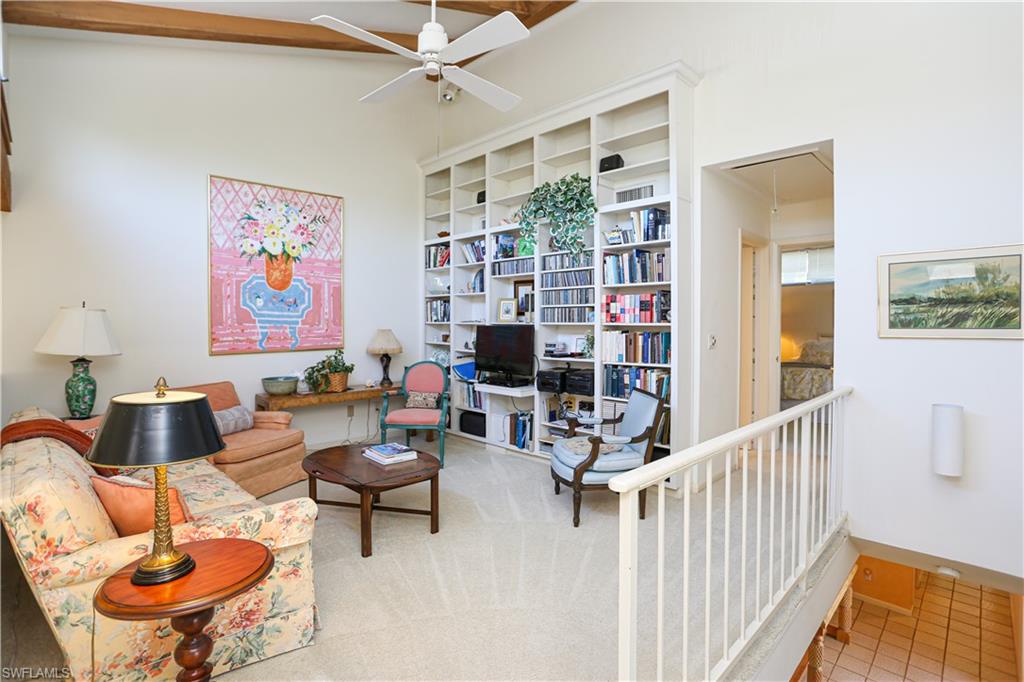 550 3rd Avenue North Naples, FL 34102 - Photo 25 of 48 a living room with furniture and a book shelf
