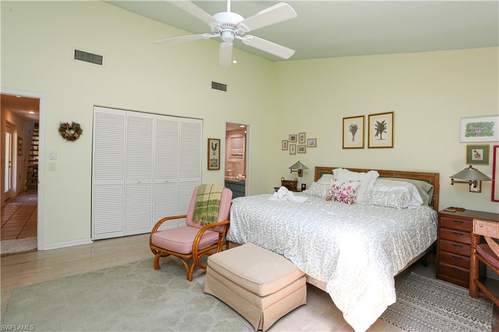 550 3rd Avenue North Naples, FL 34102 - Photo 27 of 48 a bedroom with a bed and a chandelier