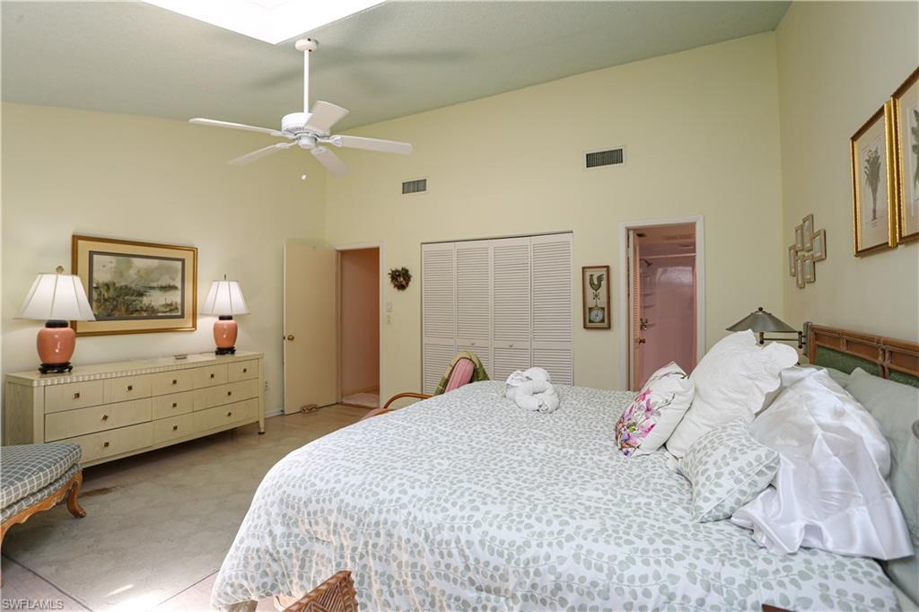 550 3rd Avenue North Naples, FL 34102 - Photo 29 of 48 a bedroom with a bed and a chandelier