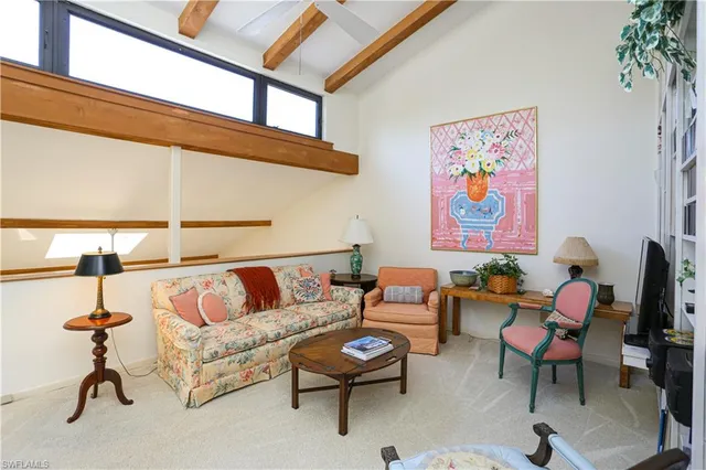 a living room with furniture a rug and a window