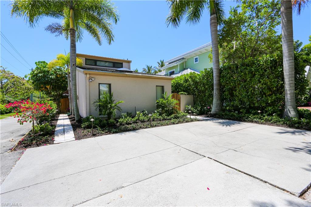 550 3rd Avenue North Naples, FL 34102 - Photo 3 of 48 a view of a garden with potted plants