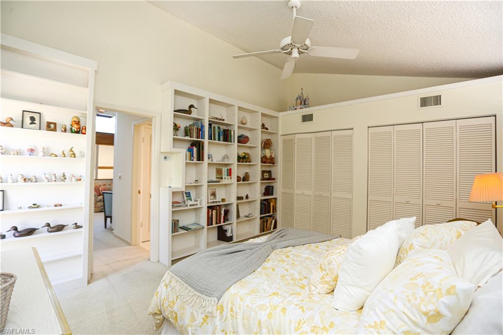 550 3rd Avenue North Naples, FL 34102 - Photo 32 of 48 a bedroom with a bed and a walk in closet