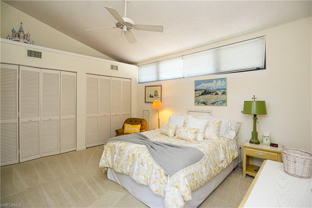 550 3rd Avenue North Naples, FL 34102 - Photo 33 of 48 a bedroom with a bed and a painting on the wall