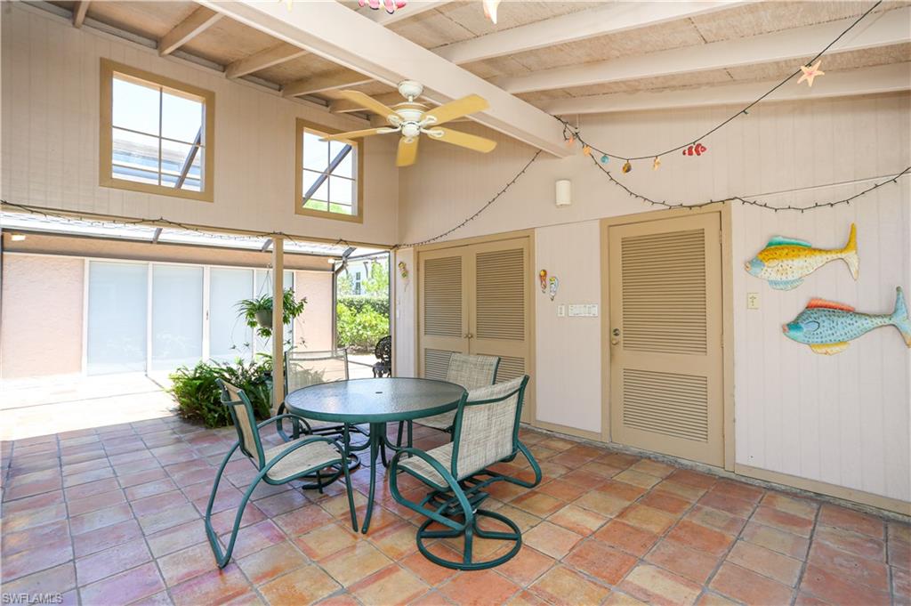 550 3rd Avenue North Naples, FL 34102 - Photo 40 of 48 a view of a dining room with furniture and a potted plant