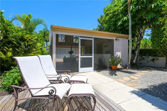 a view of a patio with table and chairs and potted plants
