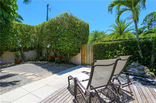 a view of a patio with table and chairs and potted plants