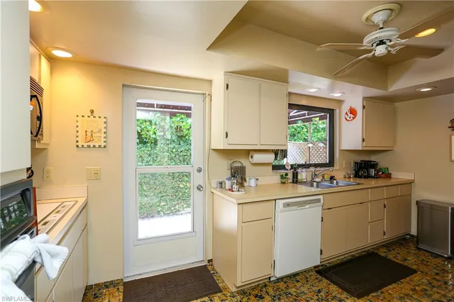a kitchen with a sink a window and cabinets