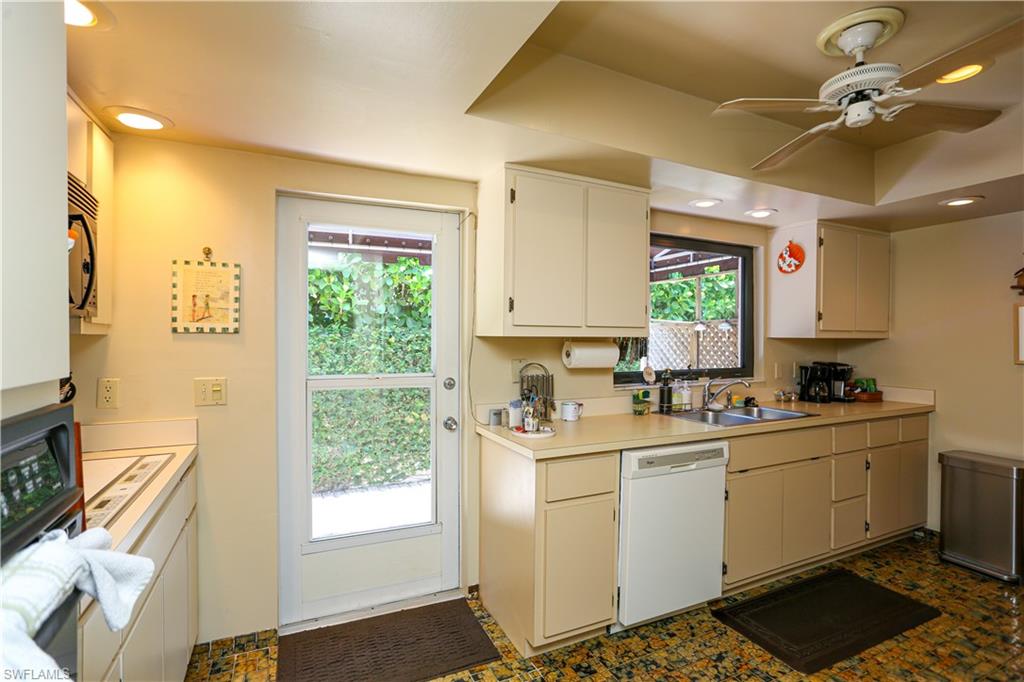 550 3rd Avenue North Naples, FL 34102 - Photo 8 of 48 a kitchen with a sink a window and cabinets