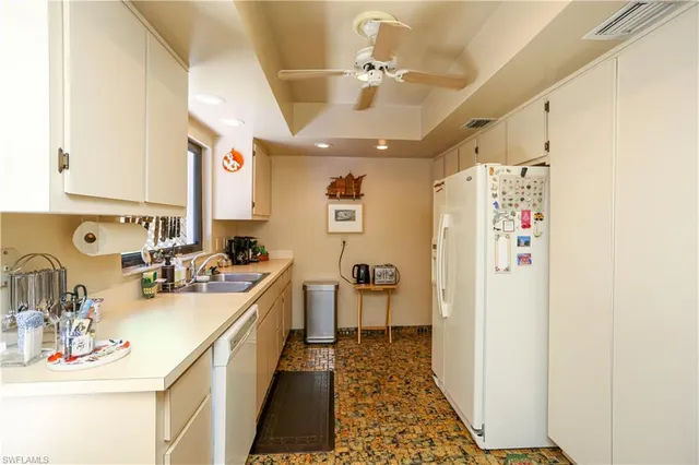 a kitchen with a sink and refrigerator