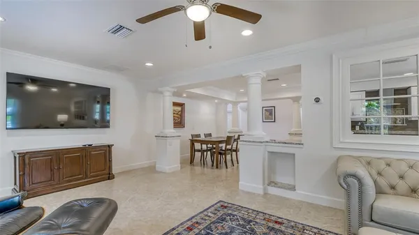 a kitchen with granite countertop living room and chandelier