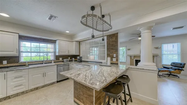 a open kitchen with cabinets a sink and appliances