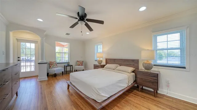 a view of a backyard with potted plants and large trees
