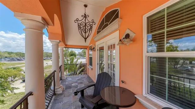a hallway with a couch and chandelier