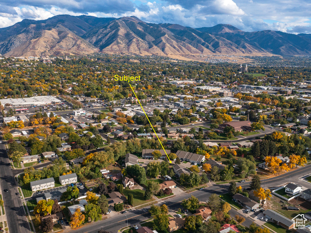 190 West 700 North Logan, UT 84321 - Photo 37 of 51 Aerial view of property and surrounding area with a mountainous background and a tree filled landscape