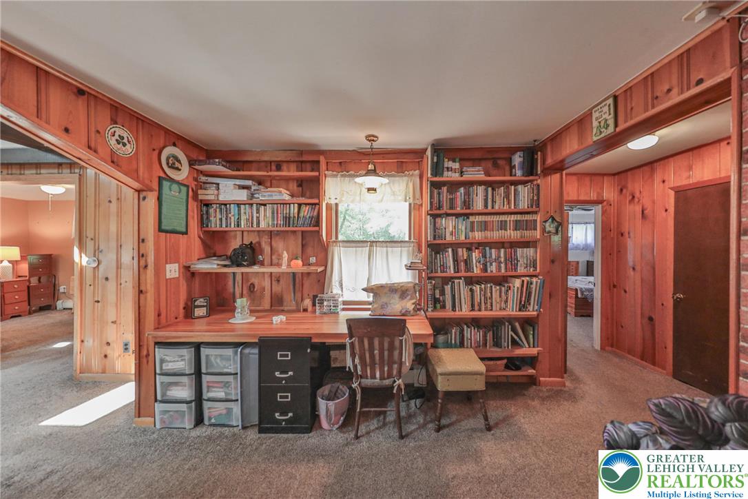 331 Cranberry Creek Road Cresco, PA 18326 - Photo 27 of 95 A quiet study space with built-in wooden bookshelves, perfect for an office or library.