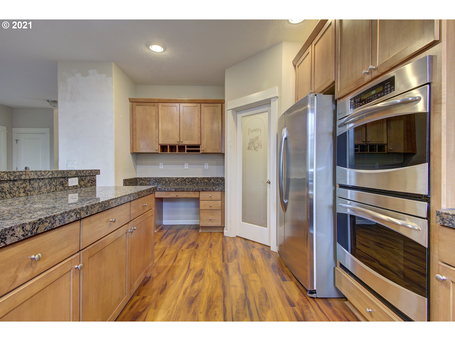 6909 Northeast Lessard Road Camas, WA 98607 - Photo 3 of 30 a kitchen with granite countertop stainless steel appliances and wooden cabinets