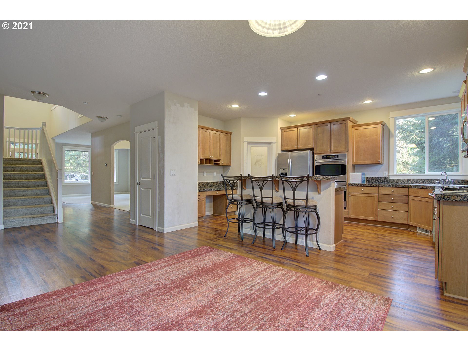 6909 Northeast Lessard Road Camas, WA 98607 - Photo 6 of 30 a open kitchen with stainless steel appliances refrigerator stove dining table and chairs