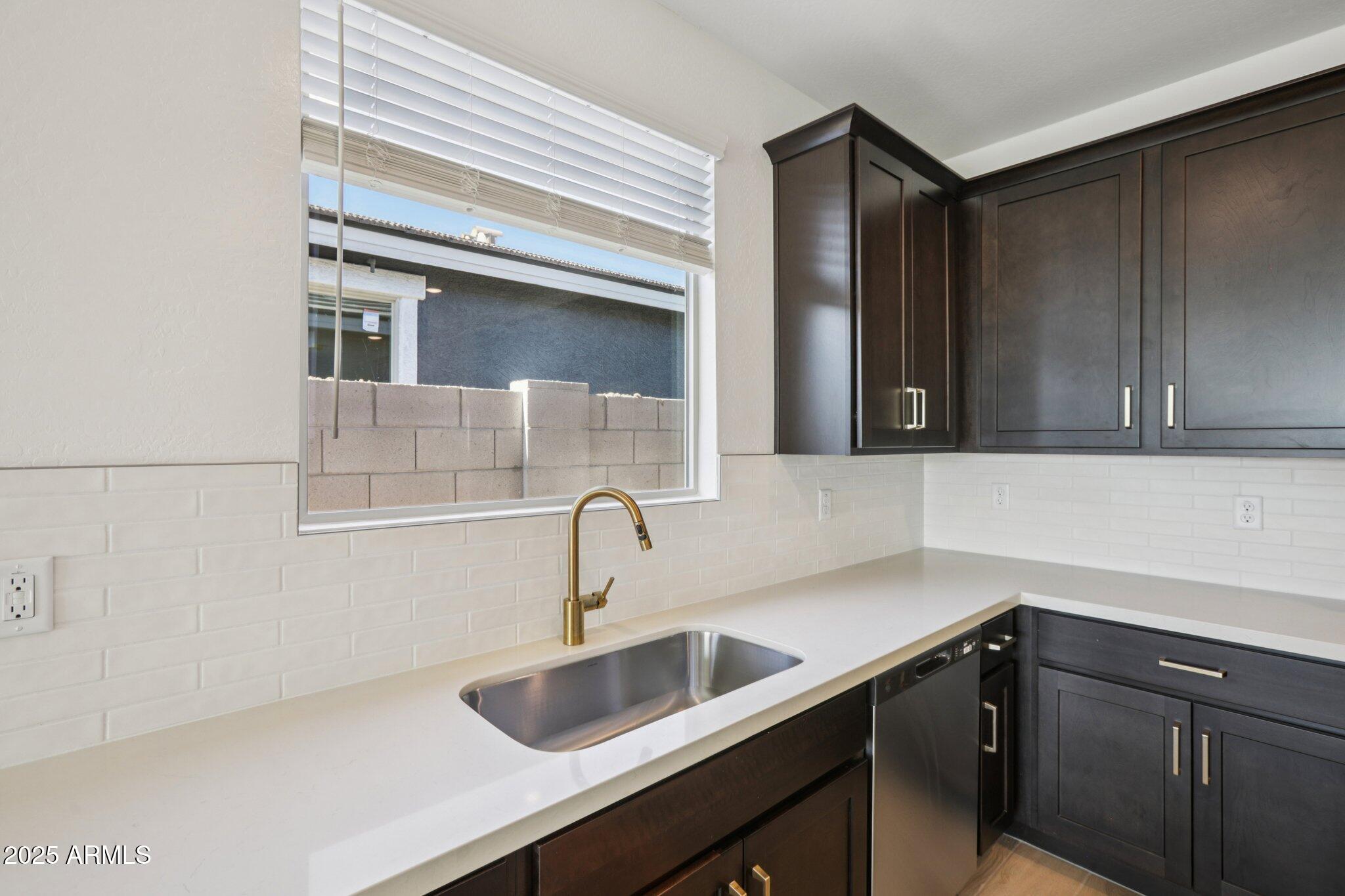 16219 West Bajada Road Surprise, AZ 85387 - Photo 11 of 43 a kitchen with a sink and cabinets