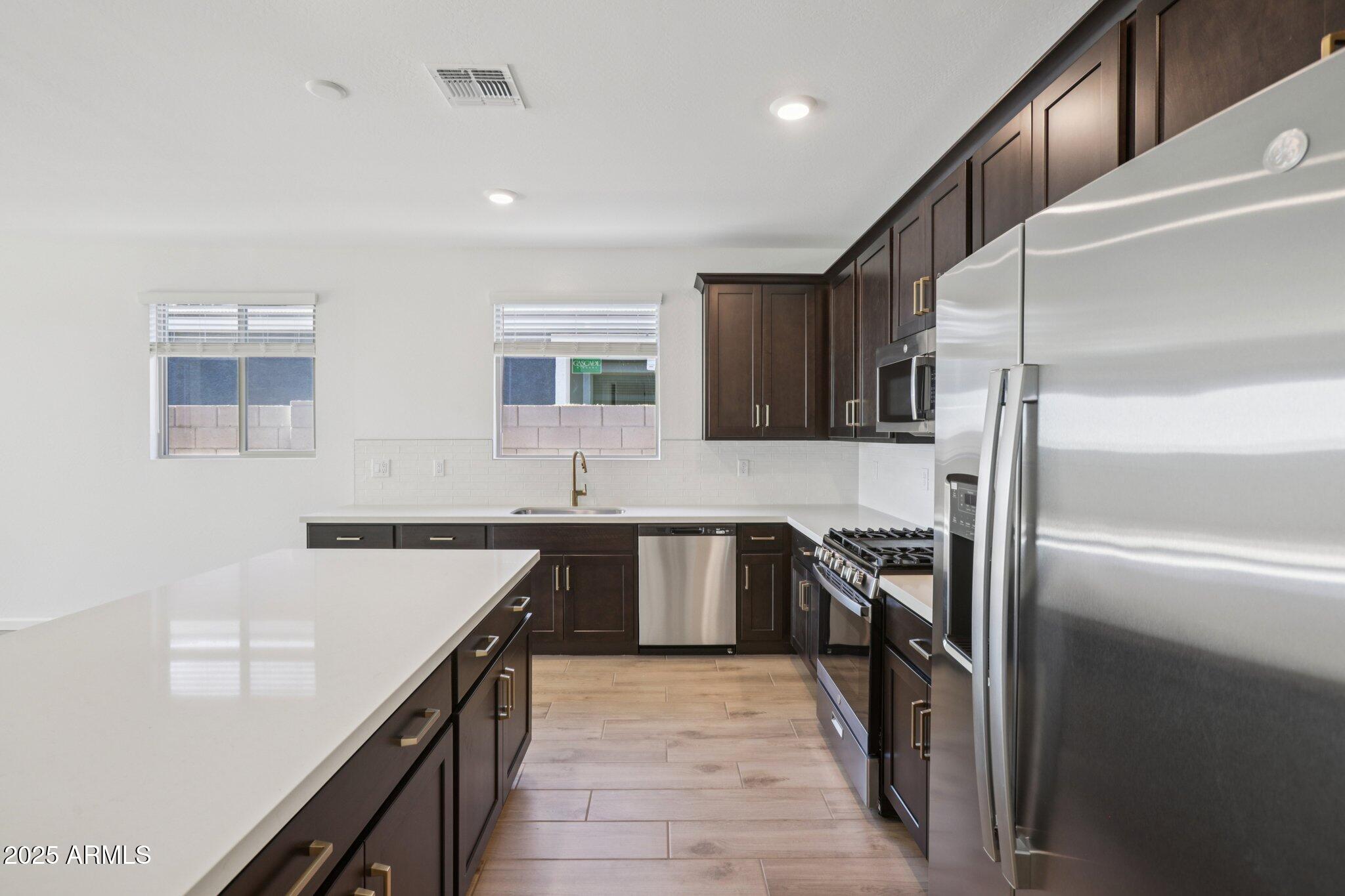 16219 West Bajada Road Surprise, AZ 85387 - Photo 12 of 43 a kitchen with a sink stove and refrigerator