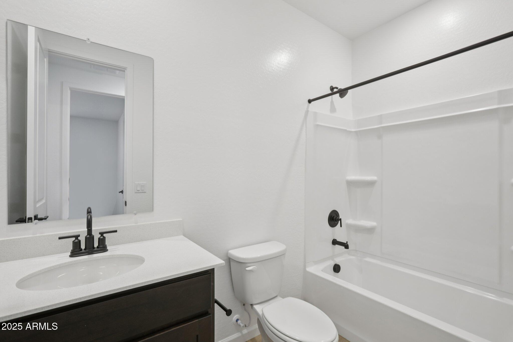 16219 West Bajada Road Surprise, AZ 85387 - Photo 23 of 43 a bathroom with a sink toilet vanity and shower