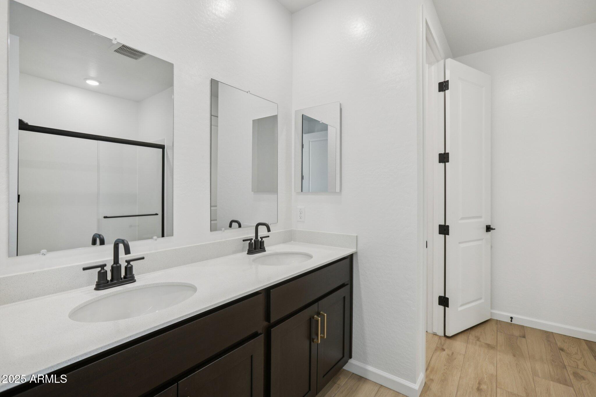 16219 West Bajada Road Surprise, AZ 85387 - Photo 25 of 43 a bathroom with double sink and mirror