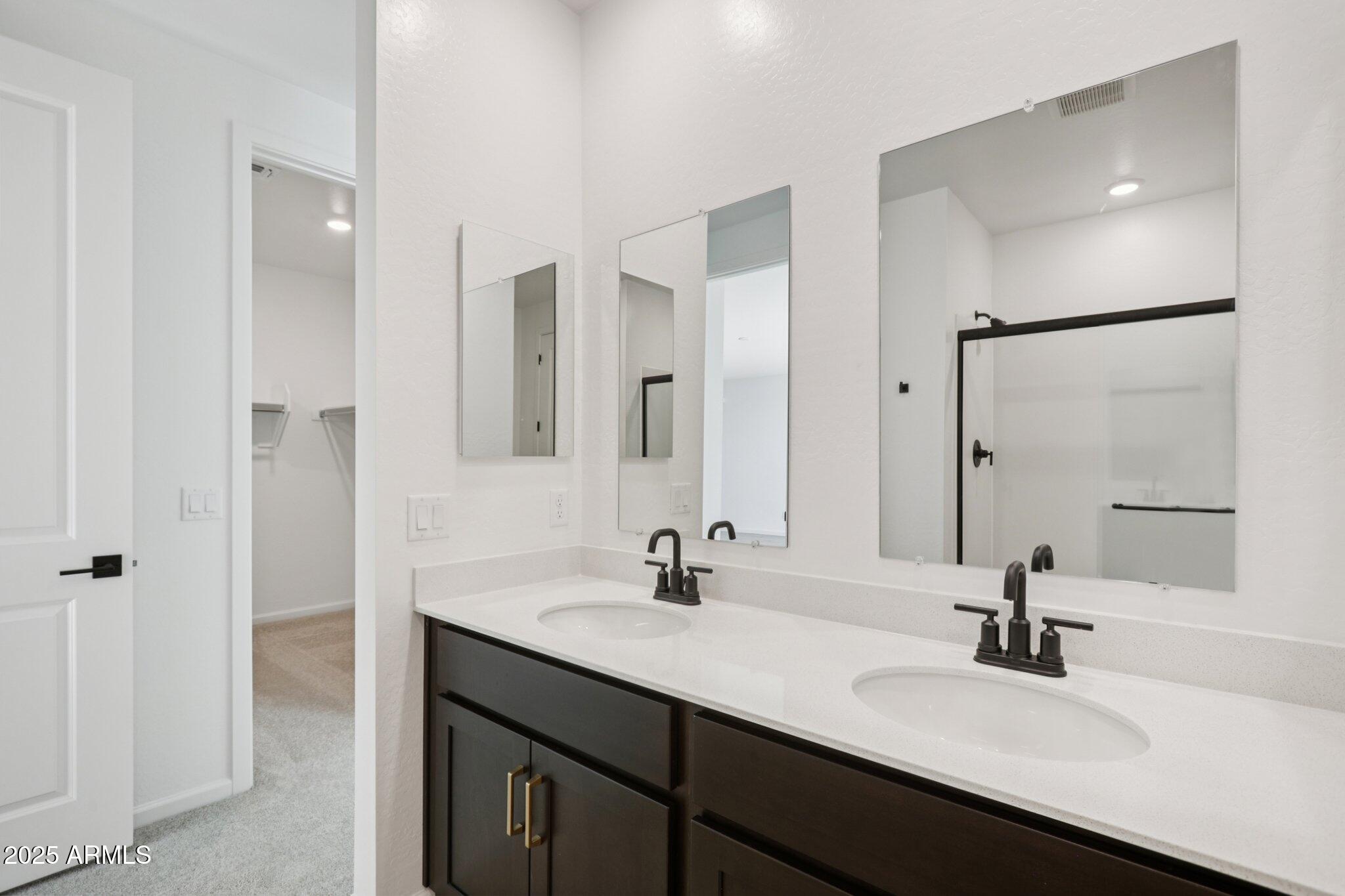16219 West Bajada Road Surprise, AZ 85387 - Photo 27 of 43 a bathroom with a sink double vanity and a mirror