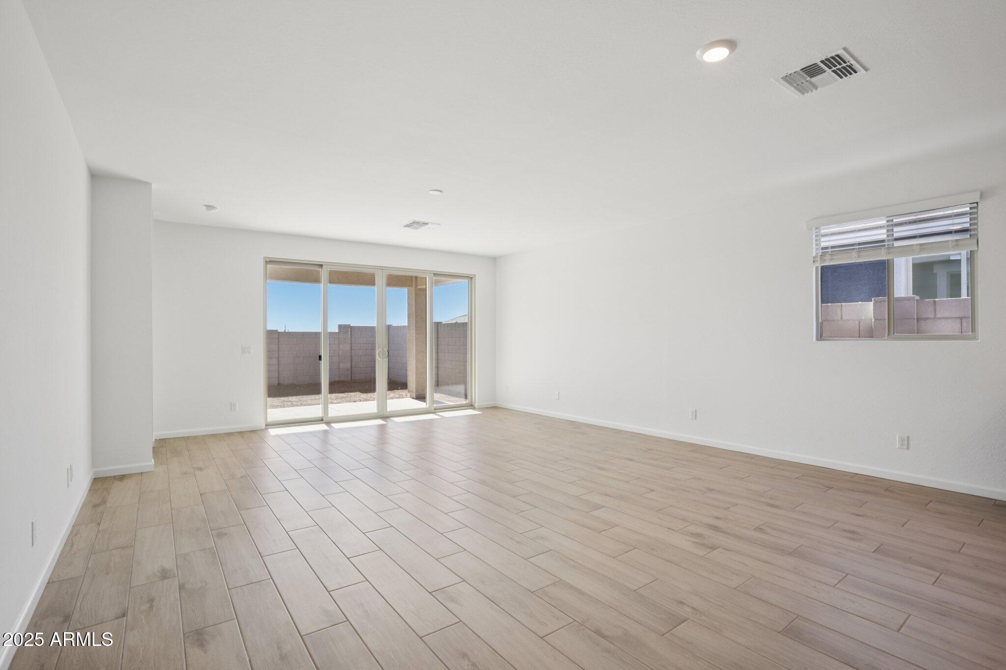 16219 West Bajada Road Surprise, AZ 85387 - Photo 5 of 43 an empty room with wooden floor and windows