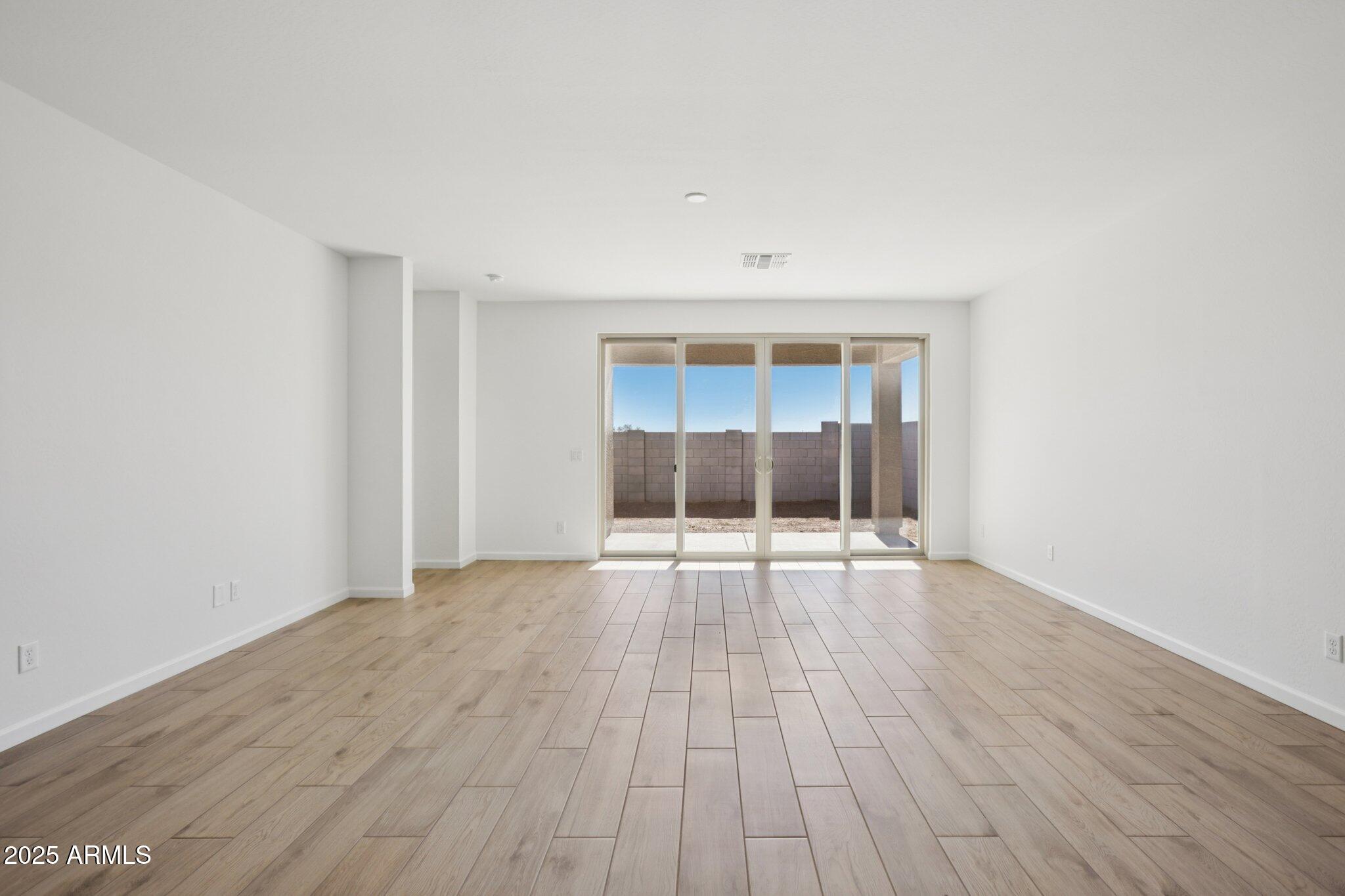 16219 West Bajada Road Surprise, AZ 85387 - Photo 8 of 43 an empty room with wooden floor and windows