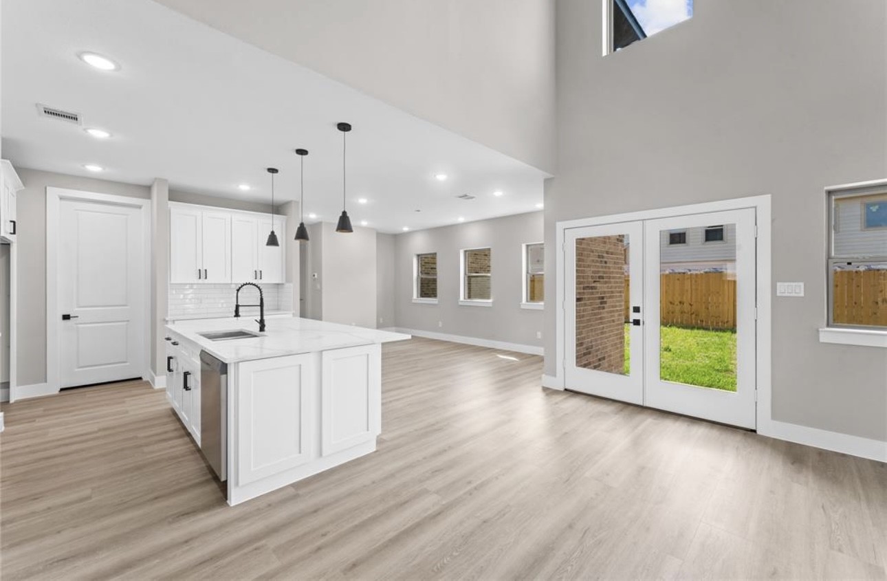 2614 Martinas Ct Spring Spring, TX 77388 - Photo 5 of 16 a large kitchen with stainless steel appliances kitchen island a large counter top and a wooden floors