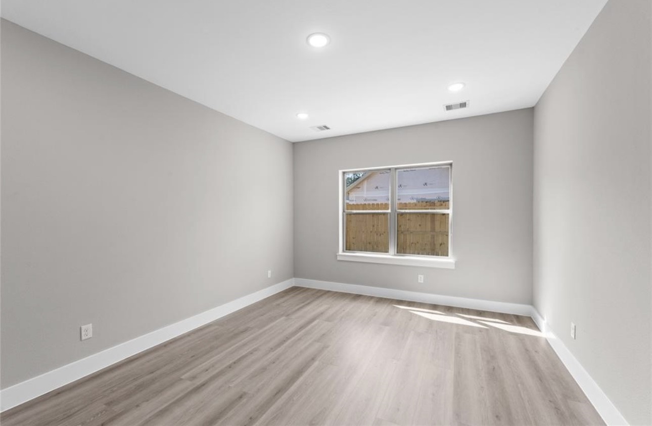 2614 Martinas Ct Spring Spring, TX 77388 - Photo 10 of 16 an empty room with wooden floor and windows