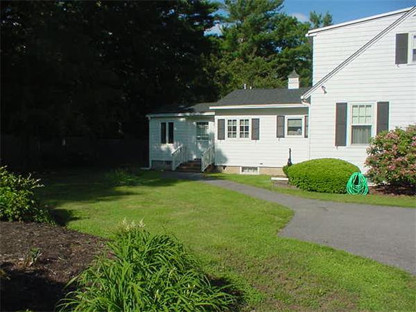 45 Shaker Lane Littleton, MA 01460 - Photo 28 of 30 a front view of a house with a garden and trees